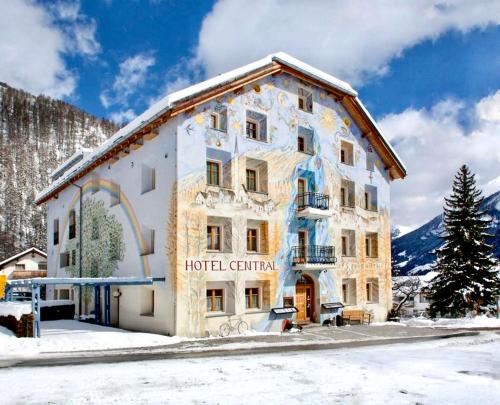 a hotel in the mountains with snow on the ground at Hotel Central La Fainera Superior in Valchava