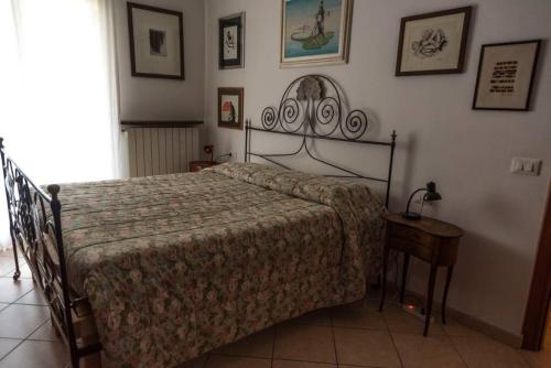 a bedroom with a bed and a table with a lamp at Casa Tiziana con Piscina privata e parcheggio riservato in Albenga