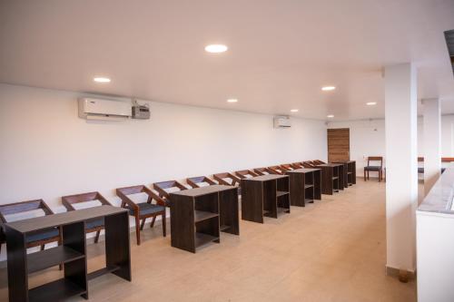 a row of tables and chairs in a room at Aaria Hills in Arambol