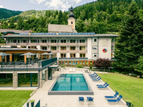 an aerial view of a hotel with a swimming pool at Evident Hotel Prägant in Bad Kleinkirchheim