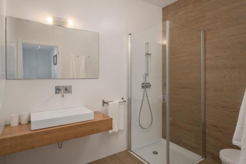 a bathroom with a shower and a sink at Casa da Maresia in Porto Santo