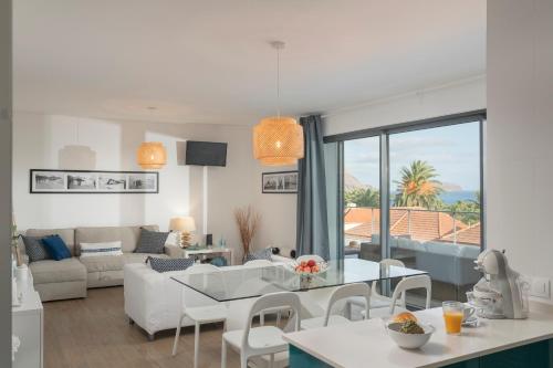 a living room with a couch and a table at Casa da Maresia by An Island Apart in Porto Santo