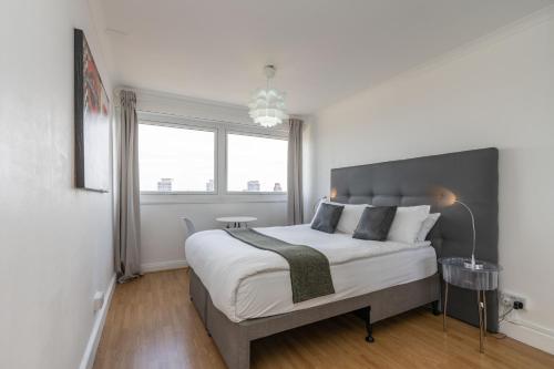 a bedroom with a large bed and a window at City View Apartments - Bow in London