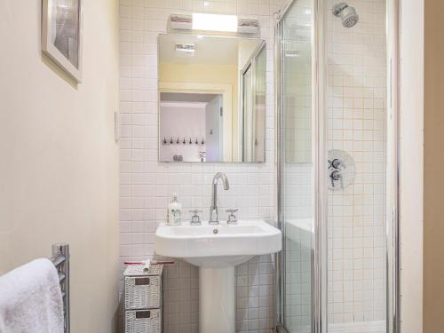 a bathroom with a sink and a shower at 15 Combehaven in Salcombe