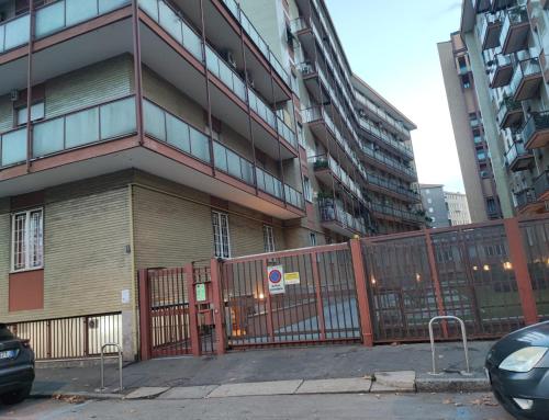 a fence in front of a building with tall buildings at CASA DI LORY in Milan