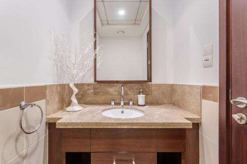 a bathroom with a sink and a mirror at WeHost - Modern 1BR Close to Burj Khalifa and Dubai Mall in Dubai