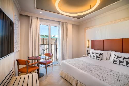 a hotel room with a bed and a table at Barceló Carmen Granada in Granada