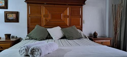 a bedroom with a large bed with towels on it at Departamento Tipo Estudio Dynasty Isla de Margarita in Porlamar