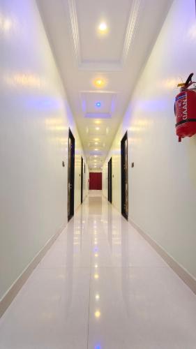a hallway of a building with doors and a bag on the ceiling at Hotel Dwarika in Chandrapur