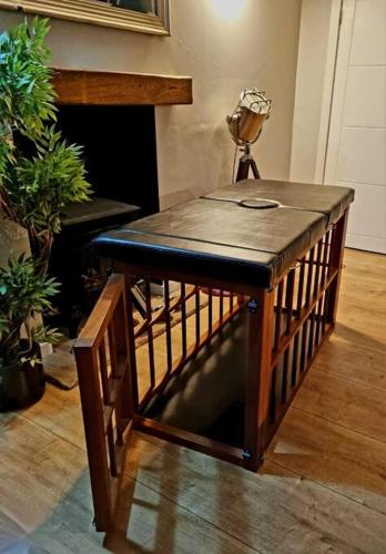 a small wooden table in a room with plants at Naughty Shades of Brighton in Brighton & Hove
