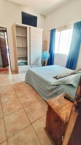 a bedroom with a bed with a wooden table in it at Lavalle II in Venado Tuerto