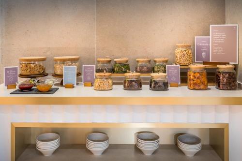 a display of jars of food on a shelf at Barceló Carmen Granada in Granada