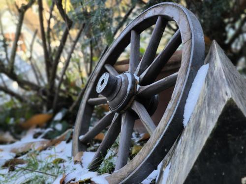 a wooden wagon wheel with snow on it at Ferienhaus The Himmelsteig in Sasbachwalden