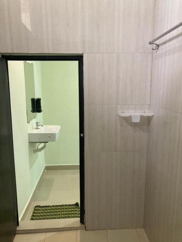 a bathroom with a sink and a shower with a mirror at Oceanic Stay And Restaurant Gokarna in Gokarn