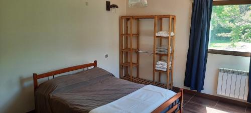 un dormitorio con una cama y una ventana en Sierras de los padres, en Mar del Plata