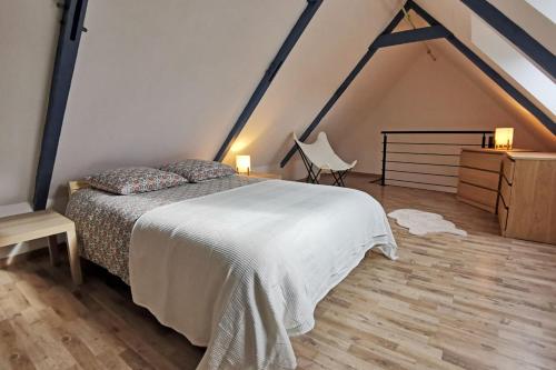 sypialnia z łóżkiem, komodą i krzesłem w obiekcie Charmante Maison de ville à 6 km de la mer w mieście Lanmeur
