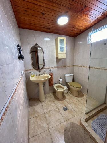 a bathroom with a sink and a toilet and a shower at Almma Mia in Godoy Cruz