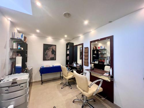 a salon with chairs and a table and a mirror at Wyndham Grand Costa del Sol in Mijas Costa