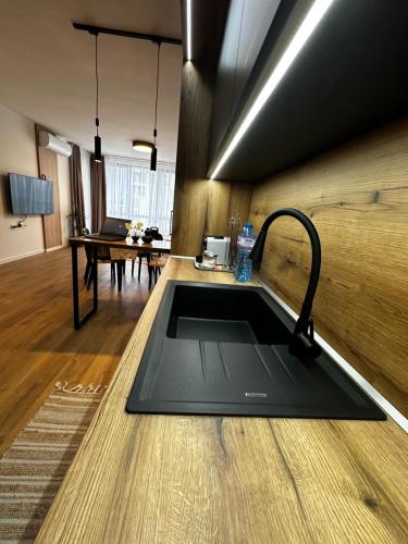 a kitchen with a sink in the middle of a room at 1BR Modern condo near the University in Sofia