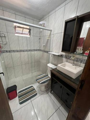 a bathroom with a shower and a toilet and a sink at Casa na Cachoeira Do Bom Jesus s in Florianópolis