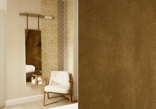 a room with a chair and a mirror at Hôtel La Nouvelle République & Hammam in Paris