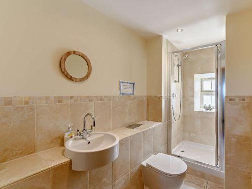 a bathroom with a sink and a toilet and a shower at 3 Bed in Nr Bamburgh CN069 in Kyloe
