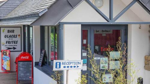a store front with a sign in front of it at Camping le Dolmen, Carnac, Morbihan in Carnac