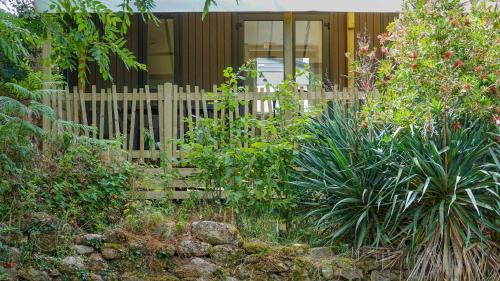 a wooden fence in front of a house at Camping le Dolmen, Carnac, Morbihan in Carnac