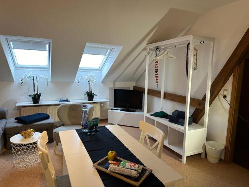 a living room with a couch and a table at Hansecottage in Stockelsdorf