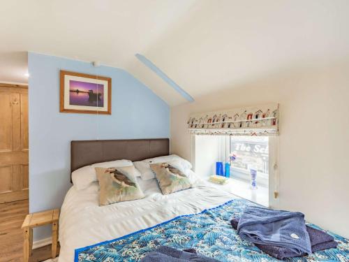 a bedroom with a bed and a window at 2 Bed in Seahouses CN116 in Seahouses