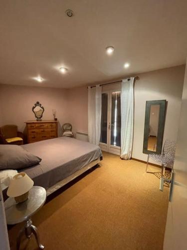 une chambre avec un grand lit et une fenêtre dans l'établissement Belle Maison en Provence, à Sérignan-du-Comtat