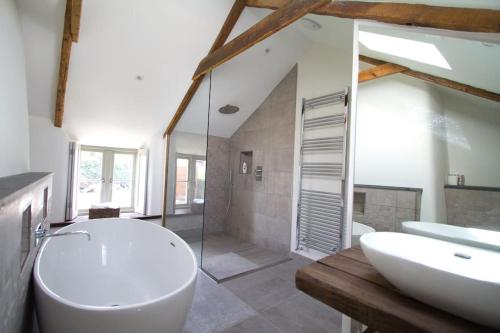 a bathroom with a toilet and a sink and a shower at Barnwell Cottage *Stunning Cornish Cottage* Oozing Charm + Comfort in Cubert