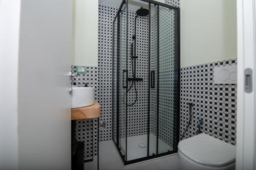 a bathroom with a toilet and a glass shower at Da Lisa all'ombra della Mole in Turin