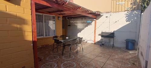 a patio with a table and chairs in a building at Casa en la serena in La Serena