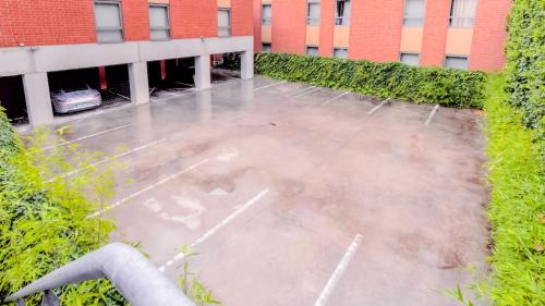 a view of a parking lot in front of a building at Hotel & Aparthotel Alize Mouscron in Mouscron
