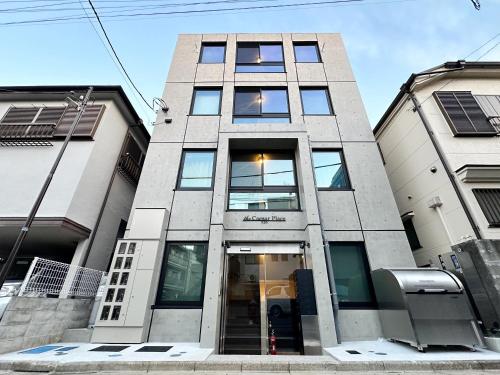 a tall building with the front door open at Caesar House Connecting Room 201and202 in Tokyo