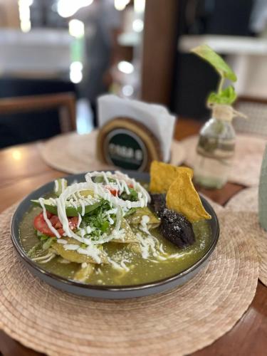 a plate of food on a table with a bowl of food at Hotel San Vicente in Playa del Carmen