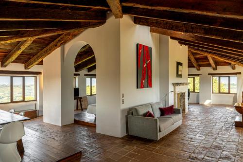 a living room with a couch and a fireplace at Castello Di Semivicoli in Casacanditella
