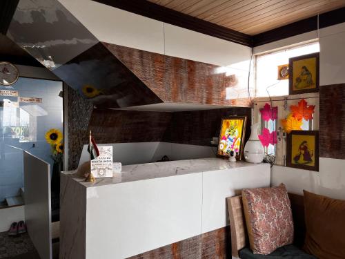 a living room with a counter and a couch at Hotel Green in Kharar