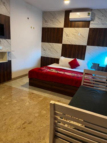 a bedroom with a bed and a bench in it at Hotel Green in Kharar
