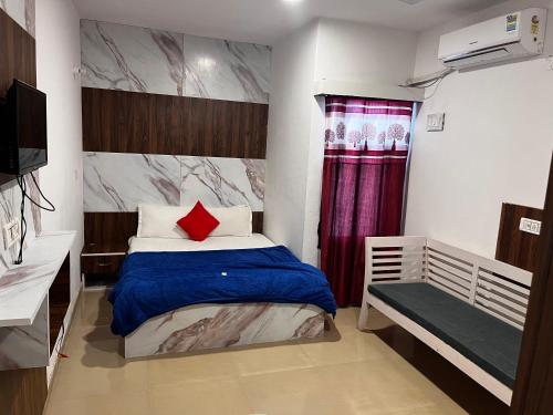 a small bedroom with a bed with a red pillow at Hotel Green in Kharar