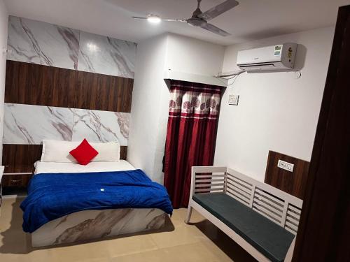 a bedroom with a bed and a red curtain at Hotel Green in Kharar