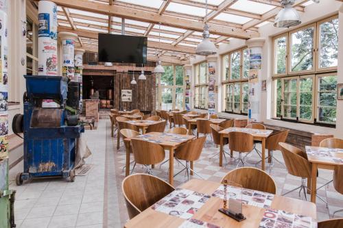 a restaurant with tables and chairs and a fireplace at Palace Inn in Jíloviště