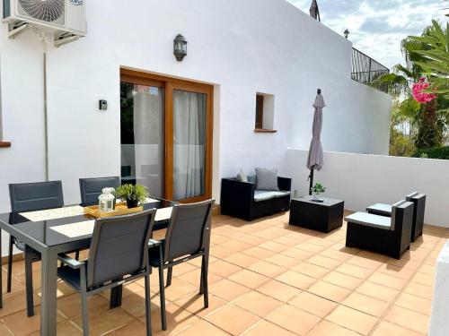 a dining room with a table and chairs and a patio at FUENGIROLA Apartament POOL & PARKING in Fuengirola