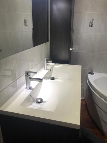 a bathroom with a white sink and a toilet at Chambre d'hôtes le Vivaldi in Seraing