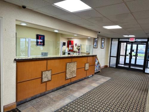 a waiting room with a counter in a building at Executive Inn in Dallas