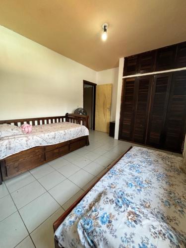 a bedroom with two beds and a rug at Casa Jambo Hostel Para Mulheres in Guarujá