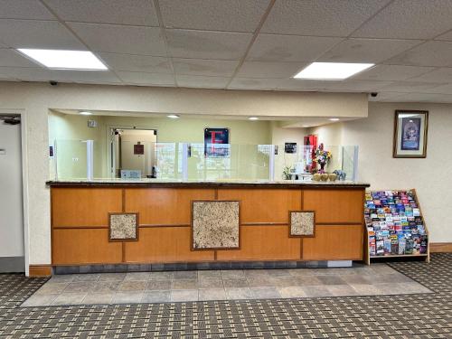 a lobby with a counter in a building at Executive Inn in Dallas