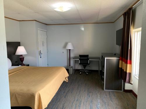 a hotel room with a bed and a desk at Pigeon Forge Parkway Inn in Pigeon Forge