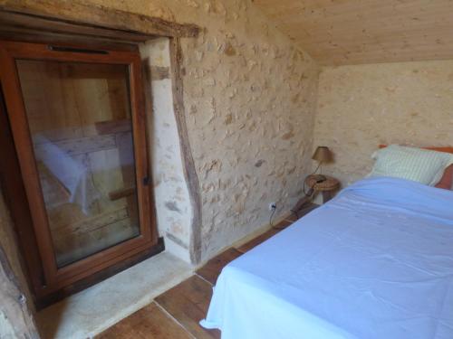 a bedroom with a bed and a window in it at Domaine de la Borde in Puy-lʼÉvêque